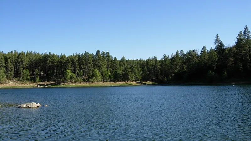 The blue water of Goldwater Lake ringed by ponderosa pines south of Prescott