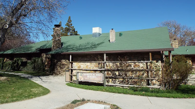 The stone-and-log Sharlot Hall Building with a green roof on the grounds of the Sharlot Hall Museum in Prescott